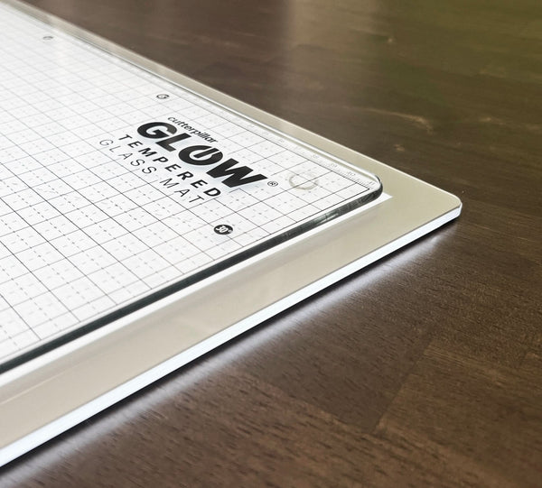 Glow tempered glass cutting mat on a wooden surface