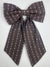 Brown patterned bow tie on a white background