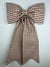 Brown and white checkered bow on a light gray background