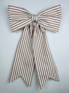 Brown and white striped bow on a light gray background