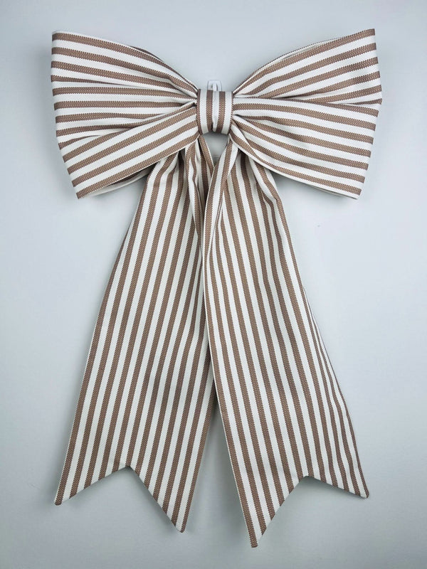 Brown and white striped bow on a light gray background