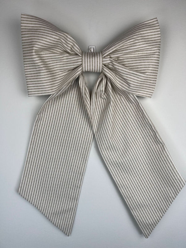 Large striped bow on a light gray background