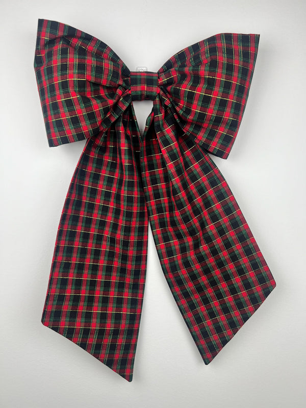 Red and green plaid bow on a white background