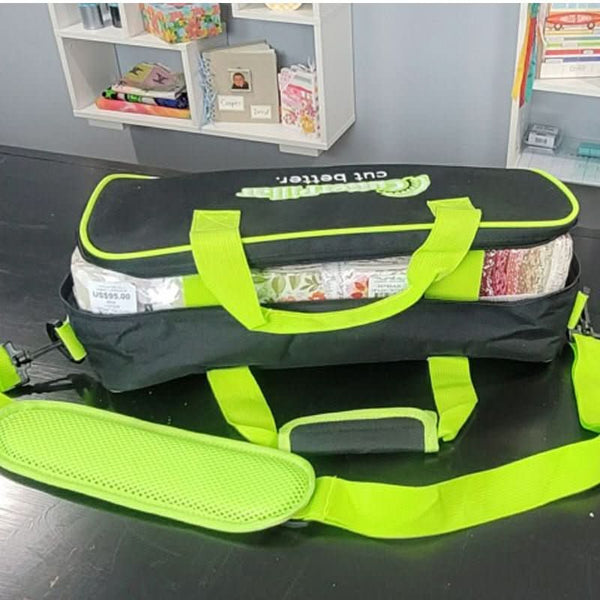 Black and green bag with items inside on a desk