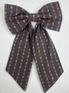 Brown patterned bow tie on a white background