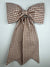 Brown and white checkered bow on a light gray background