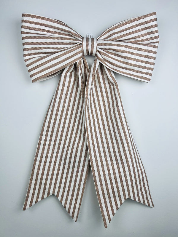 Brown and white striped bow on a light gray background