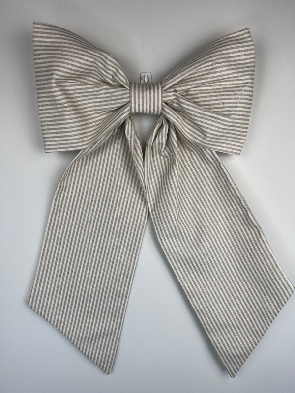 Large striped bow on a light gray background